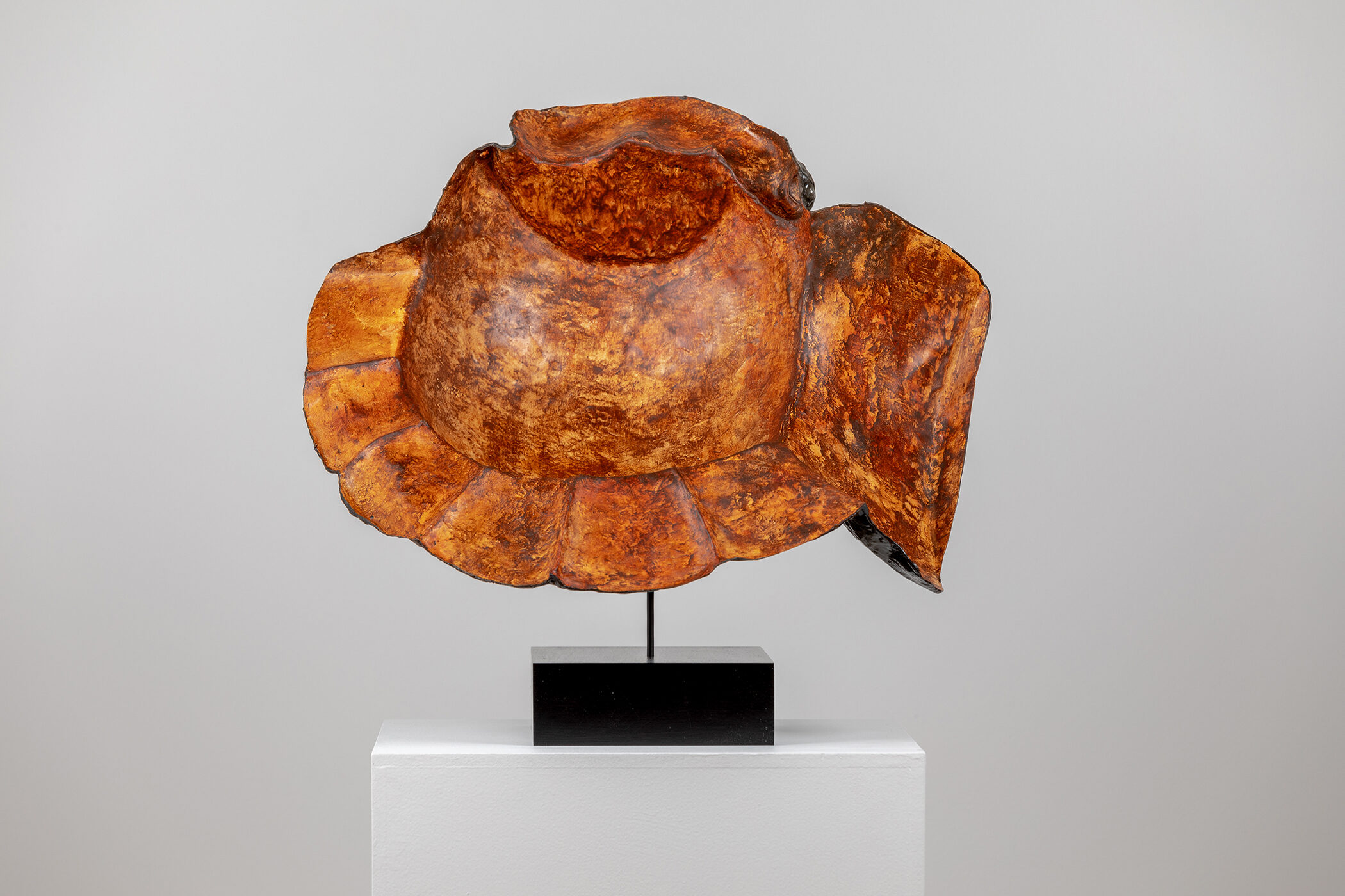 Spartan Skin (Hand in Helmet); Cold-cast nickel silver, pigmented resin, acrylic paint, pigmented wax medium, steel, dyed walnut; 16 1⁄2” x 22 3⁄4” x 15 1⁄2”; 21 3⁄4” x 22 3⁄4” x 15 1⁄2” (with base)
