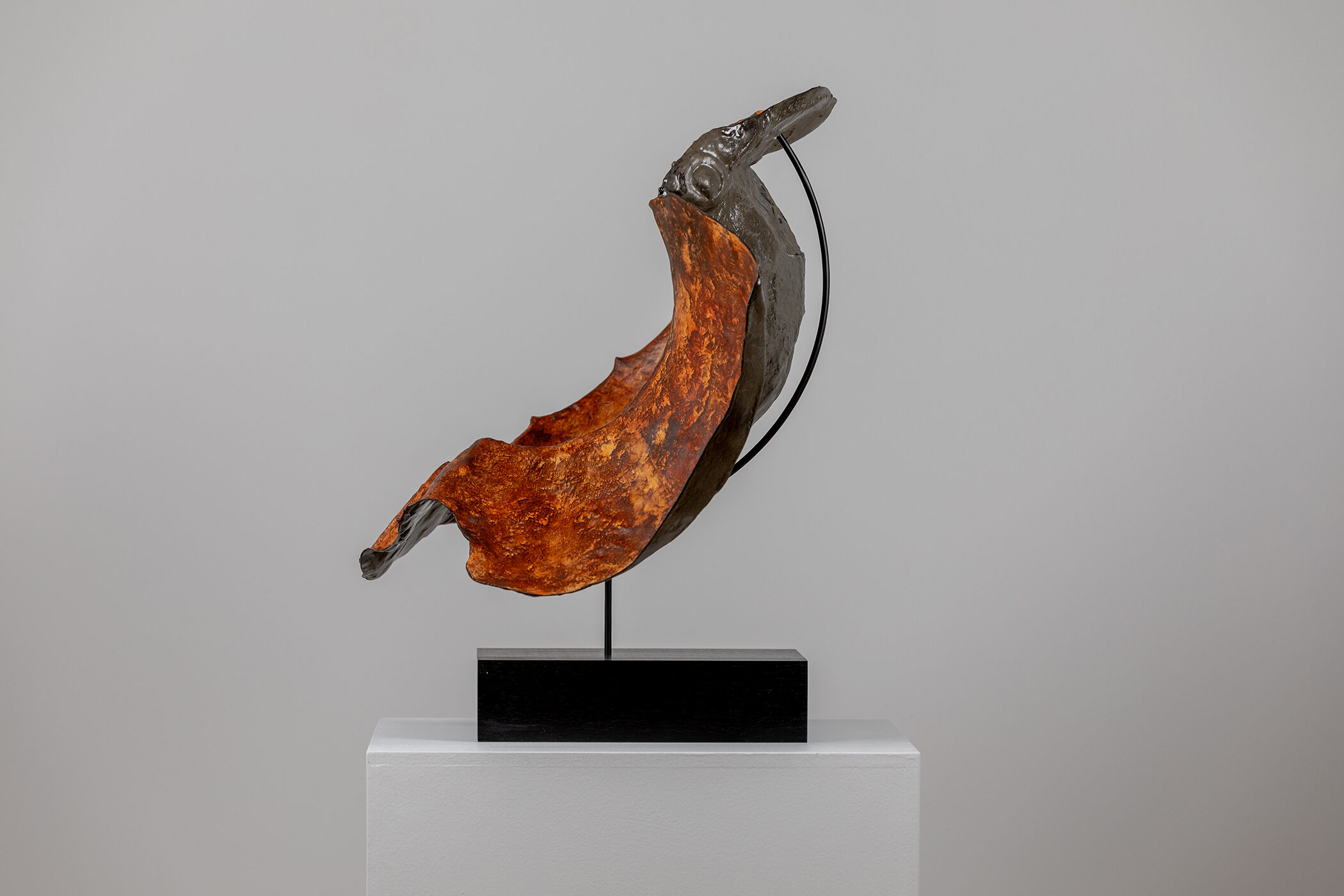 Spartan Skin (Hand in Helmet); Cold-cast nickel silver, pigmented resin, acrylic paint, pigmented wax medium, steel, dyed walnut; 16 1⁄2” x 22 3⁄4” x 15 1⁄2”; 21 3⁄4” x 22 3⁄4” x 15 1⁄2” (with base)