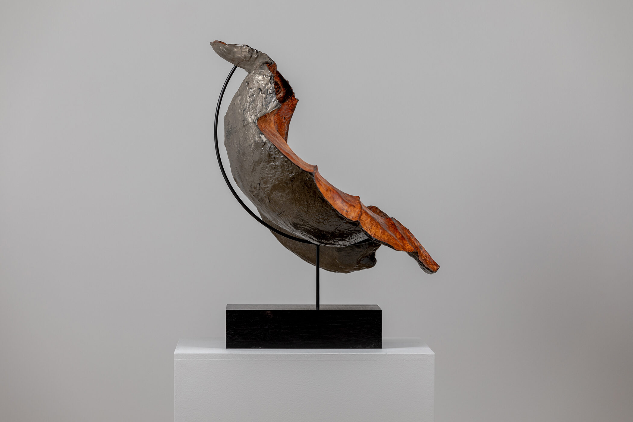 Spartan Skin (Hand in Helmet); Cold-cast nickel silver, pigmented resin, acrylic paint, pigmented wax medium, steel, dyed walnut; 16 1⁄2” x 22 3⁄4” x 15 1⁄2”; 21 3⁄4” x 22 3⁄4” x 15 1⁄2” (with base)