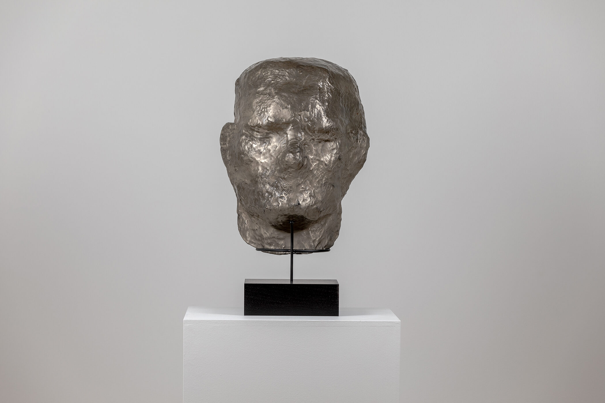 Spartan Skin (Face Mask); Cold-cast nickel silver, pigmented resin, acrylic paint, pigmented wax medium, steel, dyed walnut; 17” x 13” x 8 1⁄4”; 22 1⁄4” x 13” x 8 1⁄4” (with base)