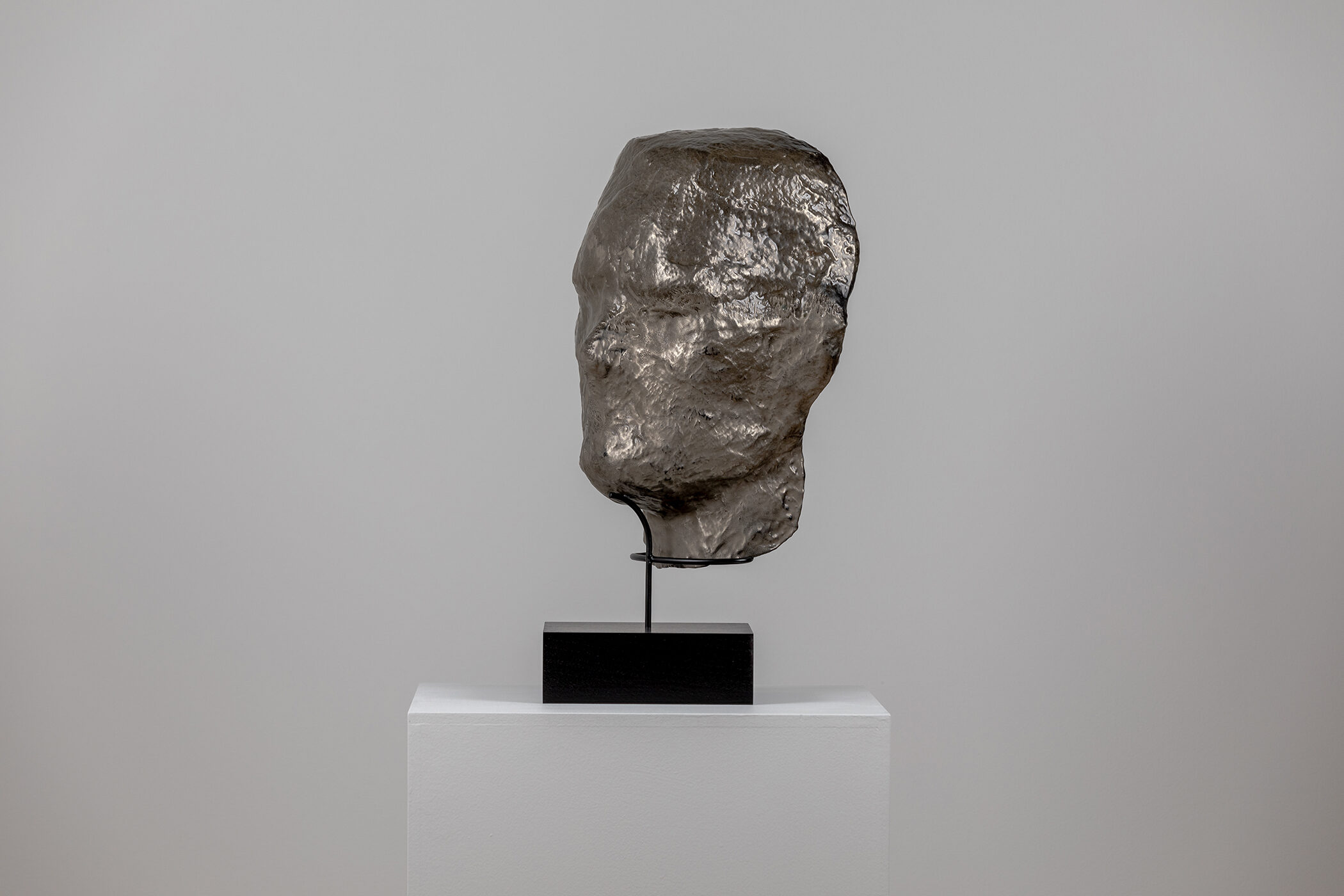 Spartan Skin (Face Mask); Cold-cast nickel silver, pigmented resin, acrylic paint, pigmented wax medium, steel, dyed walnut; 17” x 13” x 8 1⁄4”; 22 1⁄4” x 13” x 8 1⁄4” (with base)
