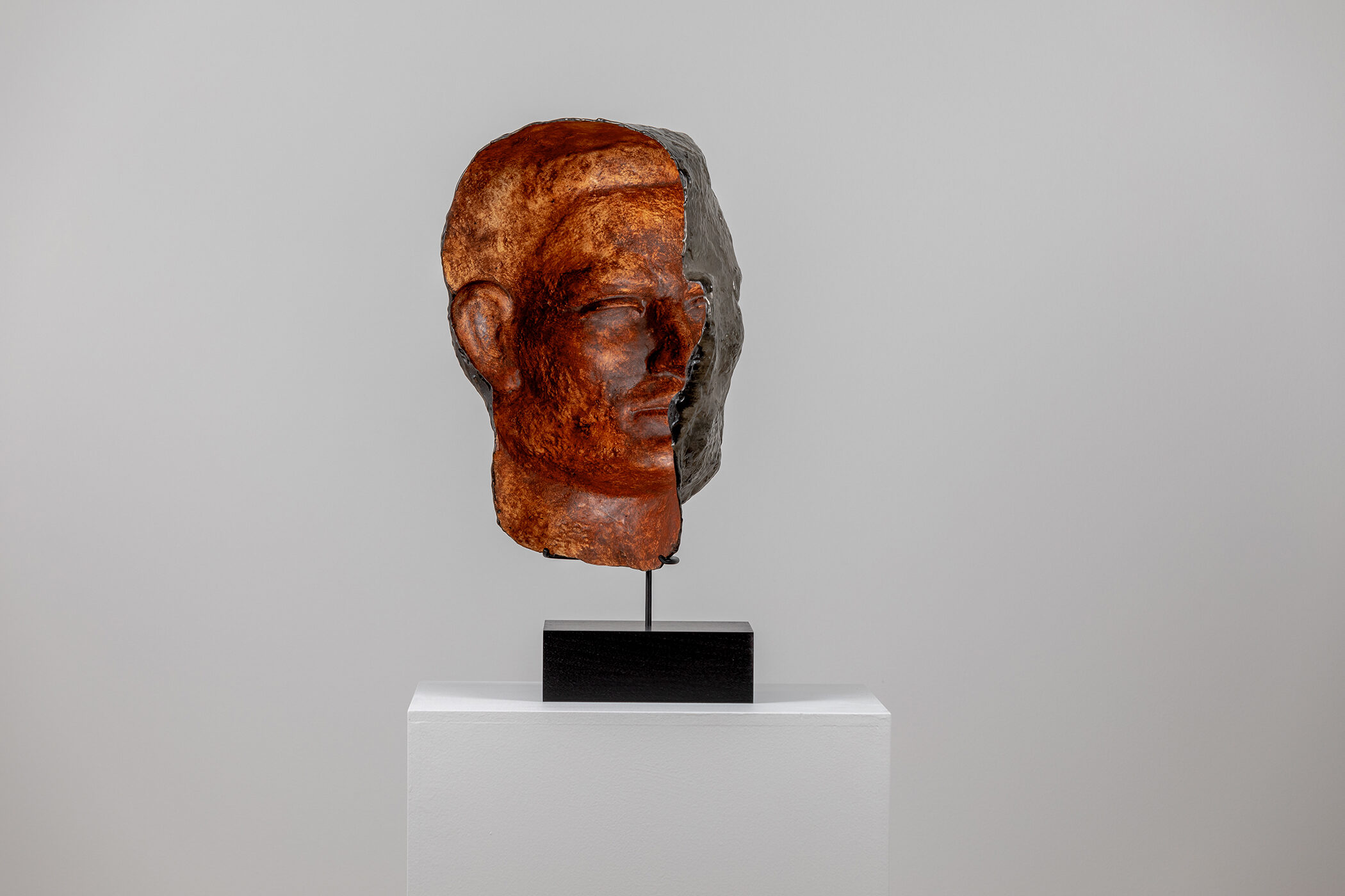 Spartan Skin (Face Mask); Cold-cast nickel silver, pigmented resin, acrylic paint, pigmented wax medium, steel, dyed walnut; 17” x 13” x 8 1⁄4”; 22 1⁄4” x 13” x 8 1⁄4” (with base)