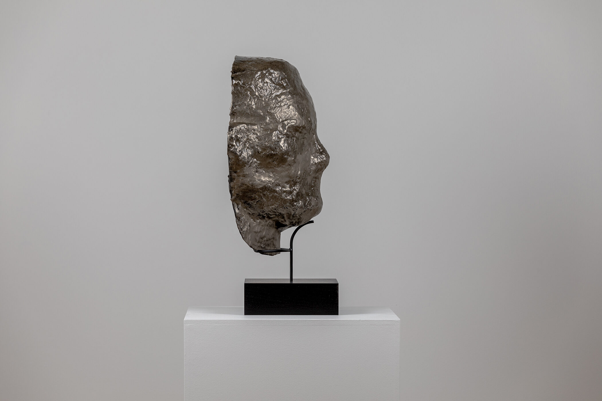 Spartan Skin (Face Mask); Cold-cast nickel silver, pigmented resin, acrylic paint, pigmented wax medium, steel, dyed walnut; 17” x 13” x 8 1⁄4”; 22 1⁄4” x 13” x 8 1⁄4” (with base)