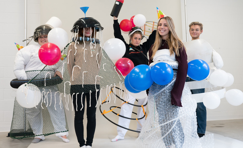 group of five people dressed up in costumes made from funnels, bubble wrap, balloons, and mesh