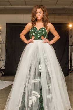 Model wearing a dress. The bottom is white toole with a green and white top