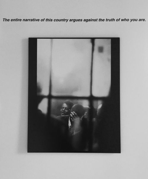 "the entire narrative of this country argues against the truth of who you are" with black and white picture of two African-American men underneath it