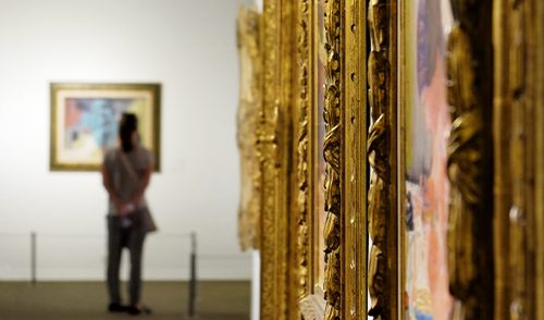 museum with paintings in intricate gold frames